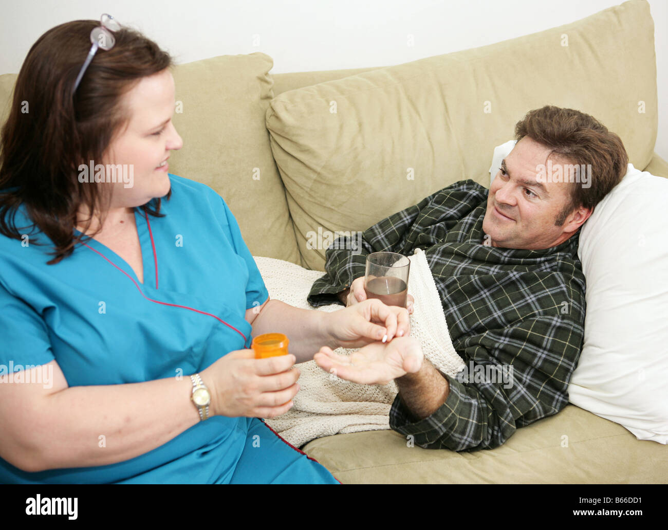 Home Health Care Nurse Giving A Pill To Her Patient Stock Photo in Giving Home Health Care Home Health Care Nurse Giving A Pill To Her Patient Stock Photo in Giving Home Health Care