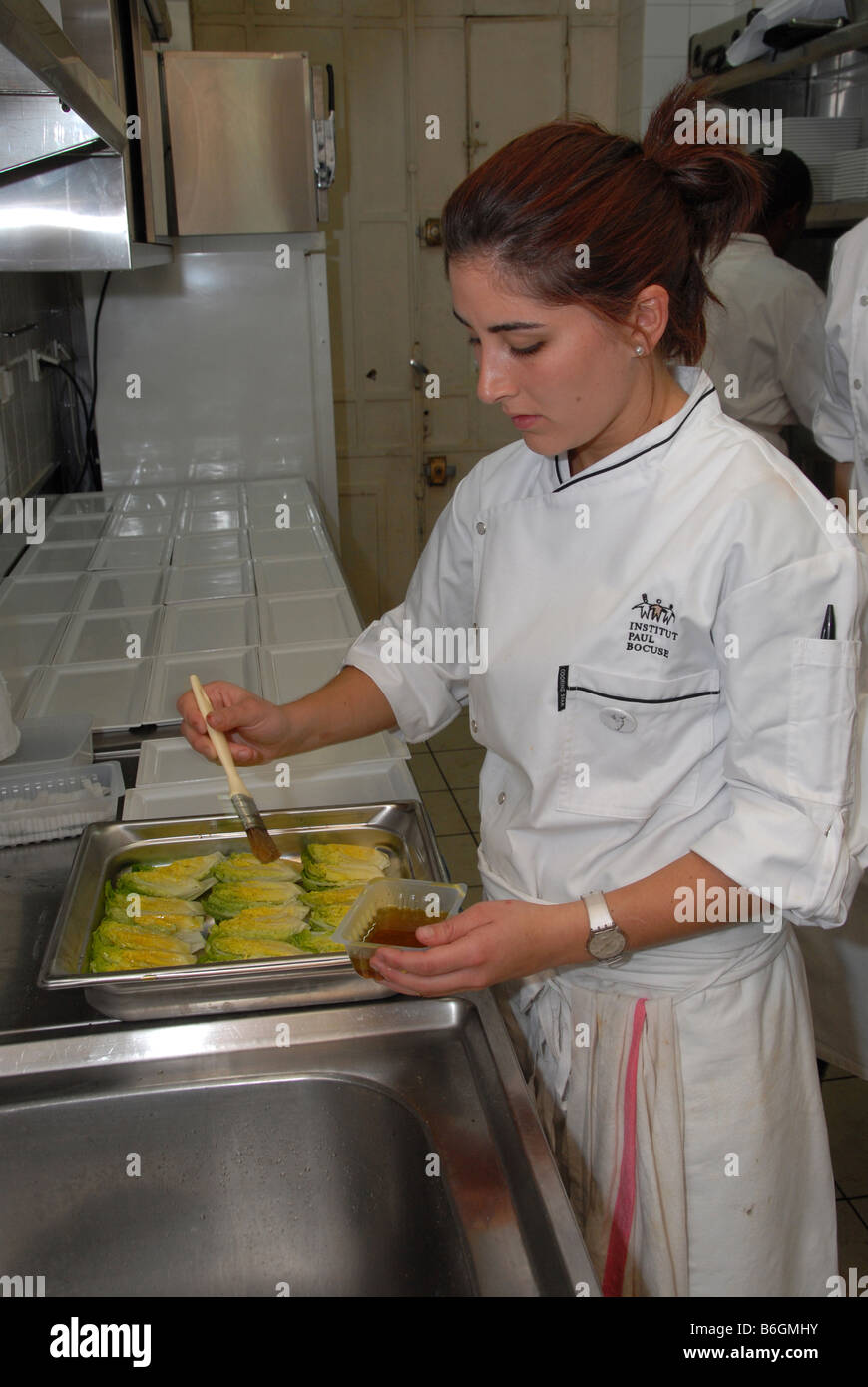 Busy Kitchen a young girl chef in a busy kitchen at the cafe de la cloche in Busy Kitchen a young girl chef in a busy kitchen at the cafe de la cloche in