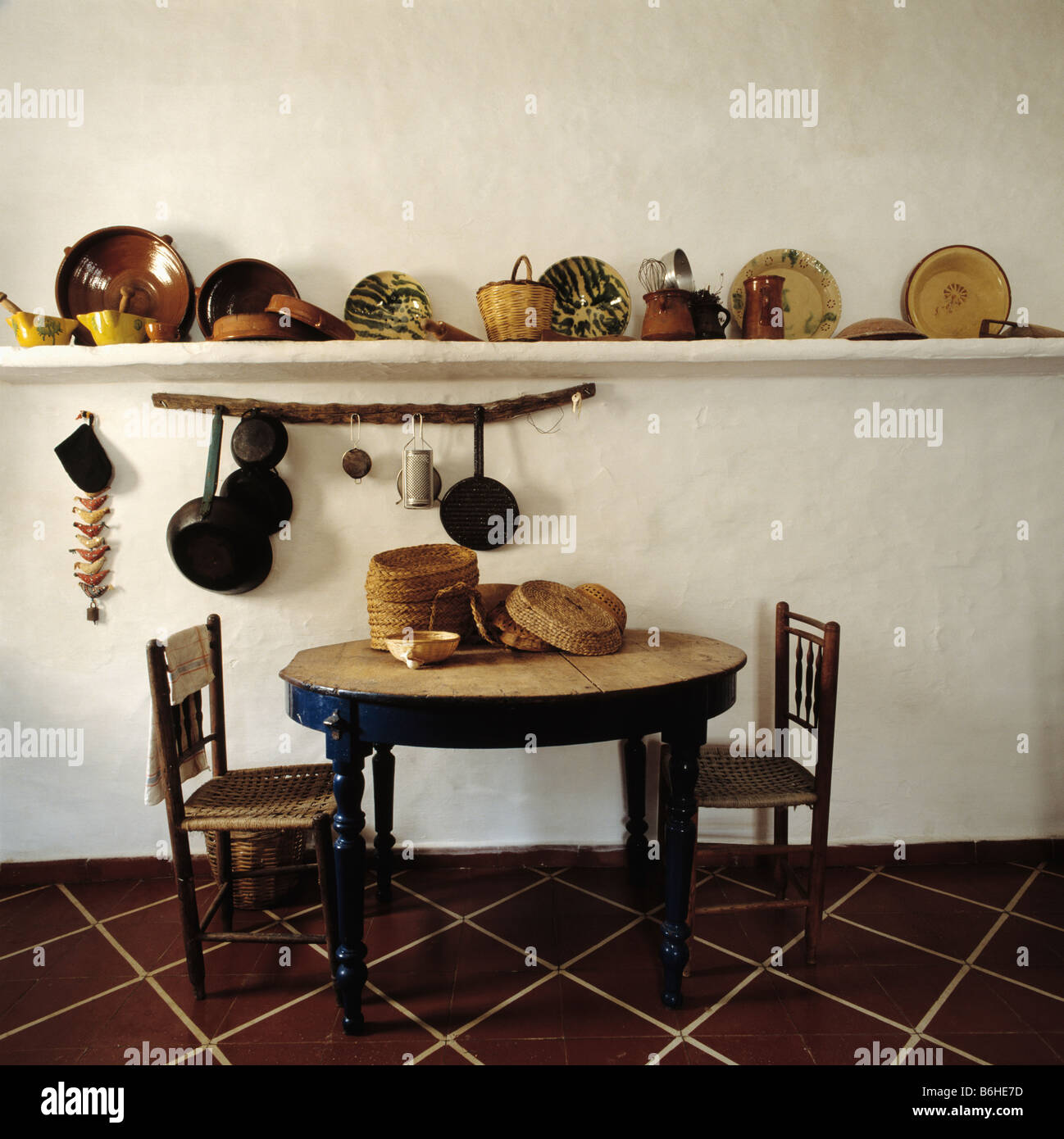 circular table and old wooden chairs in kitchen dining room with circular table and old wooden chairs in kitchen dining room with