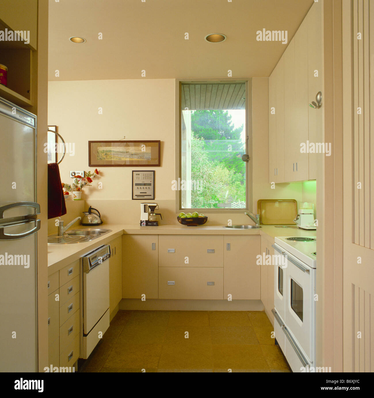 Modern cream galley kitchen with white oven and dishwasher Stock Modern cream galley kitchen with white oven and dishwasher Stock