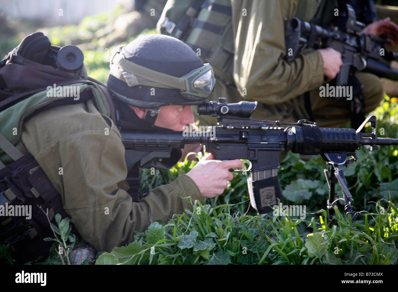 Israeli soldiers shooting rubber bullets at Palestinian stone Stock