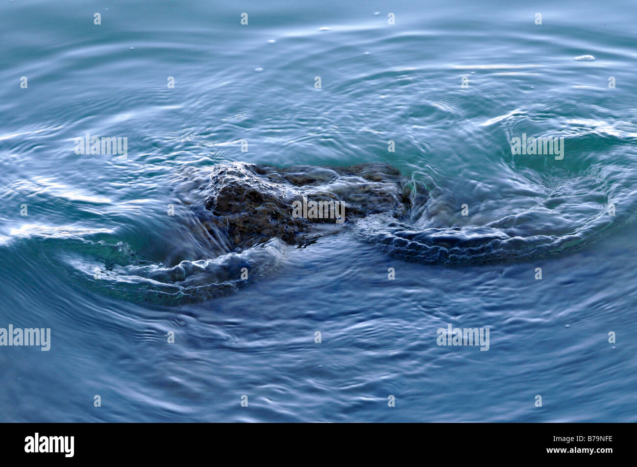 a rock under the surface of the sea water hidden dangers and hazards