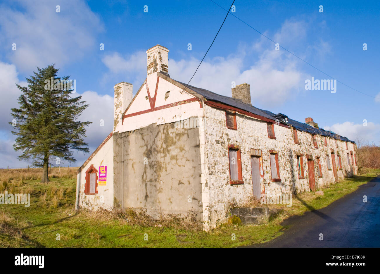 Boarded up derelict row of 4 terraced stone cottages for sale by Stock Photo, Royalty Free Image