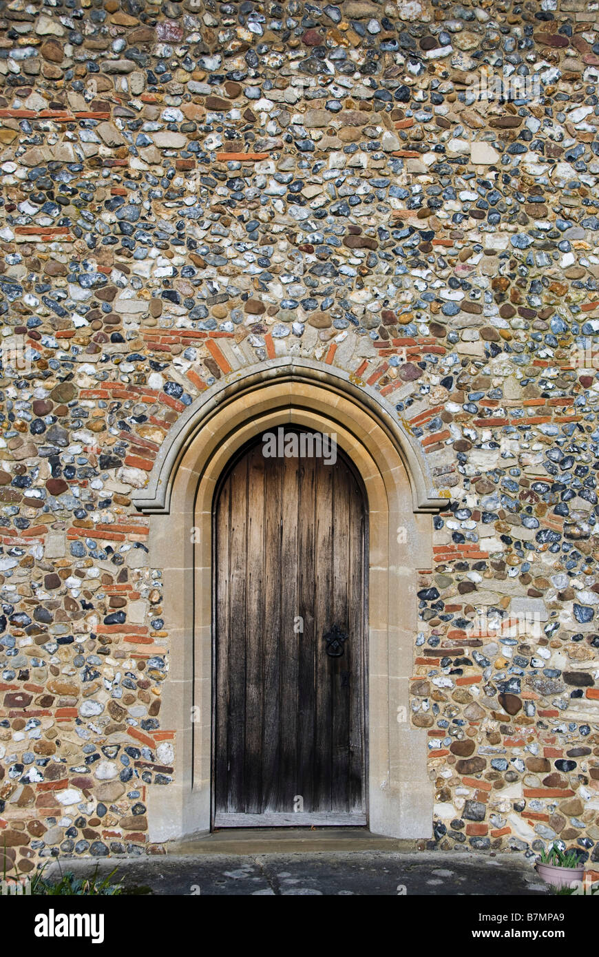 Flint wall of a church. "St Augustine of Canterbury", Birdbrook Stock