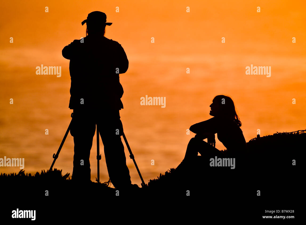 silhouette-of-photographer-and-woman-by-