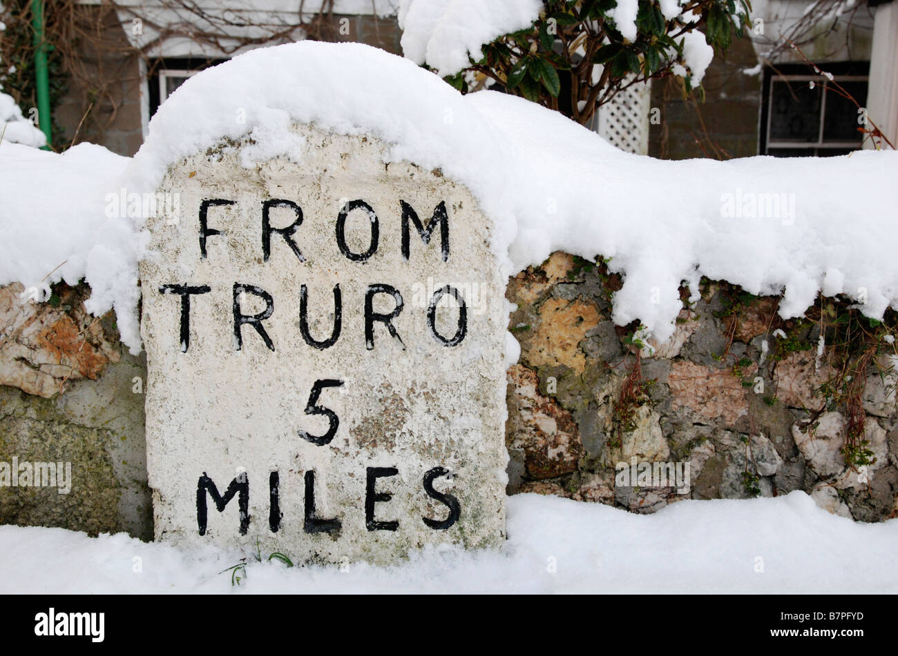 A Snow Covered Milestone Showing 5 Miles To Truro,cornwall,uk Stock