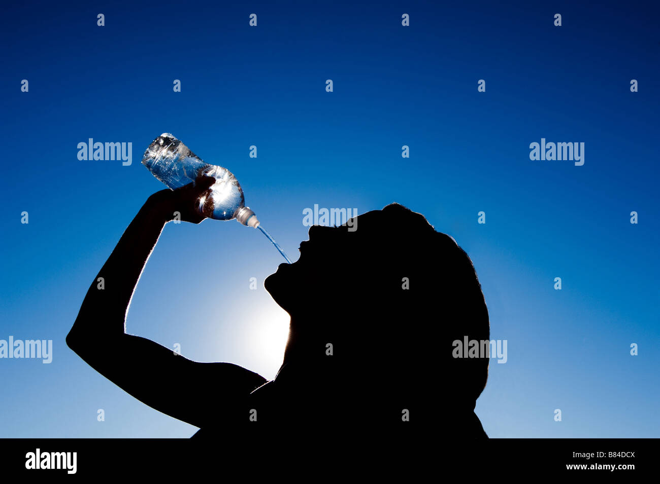 Graphic Image Of Woman Pouring Water Into Her Mouth Silhouetted Against