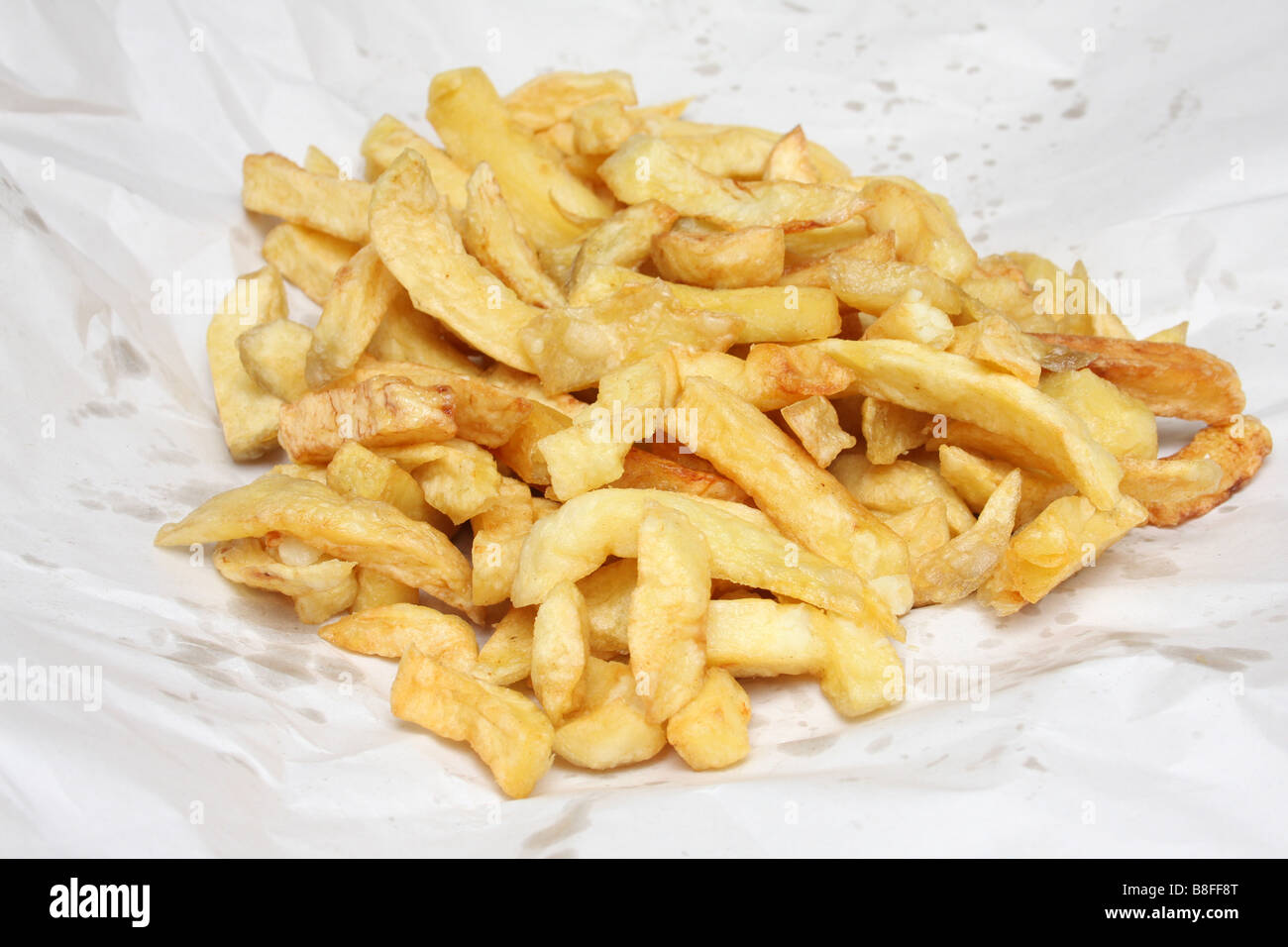 Chip shop chips in their paper wrapping Stock Photo, Royalty Free Image