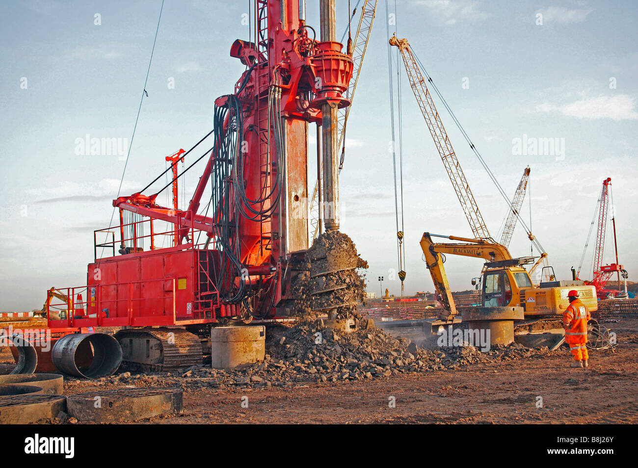 Rotary drilling rig spinning excavated material from its drill screw