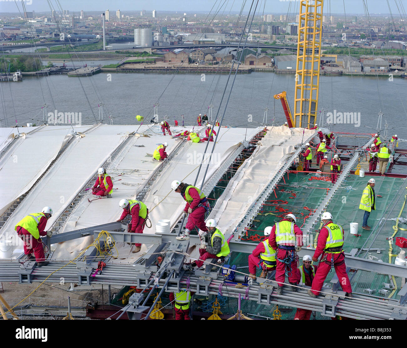 Attaching the PFTEcoated fabric roof to the cable net structure Stock