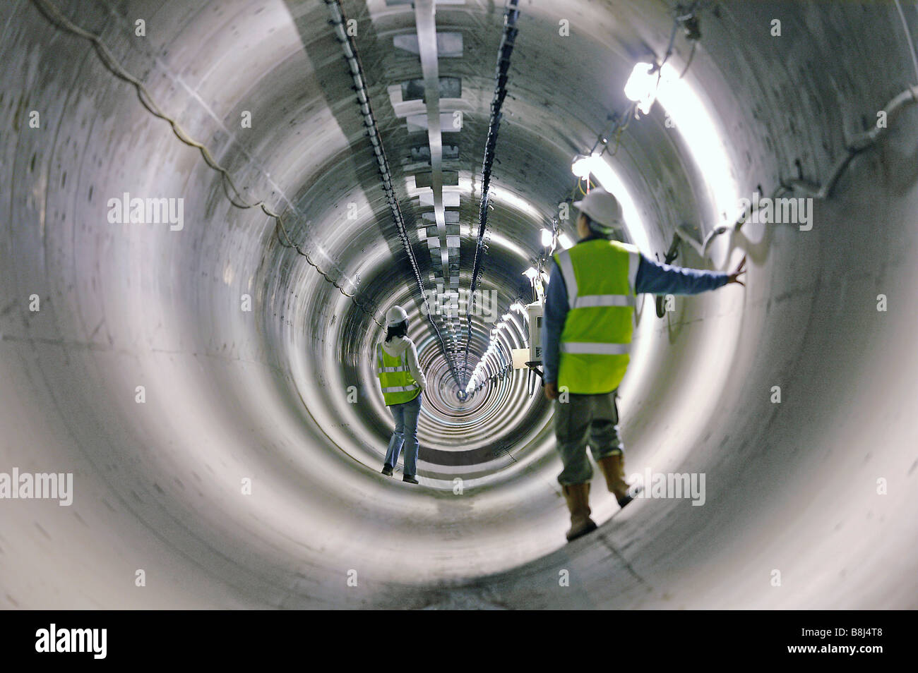 Engineers examine a section of completed power cable tunnel in Stock