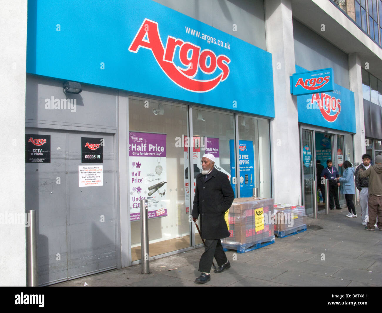 UK.Muslim people walk past Argos store in Whitechapel Road,east Stock
