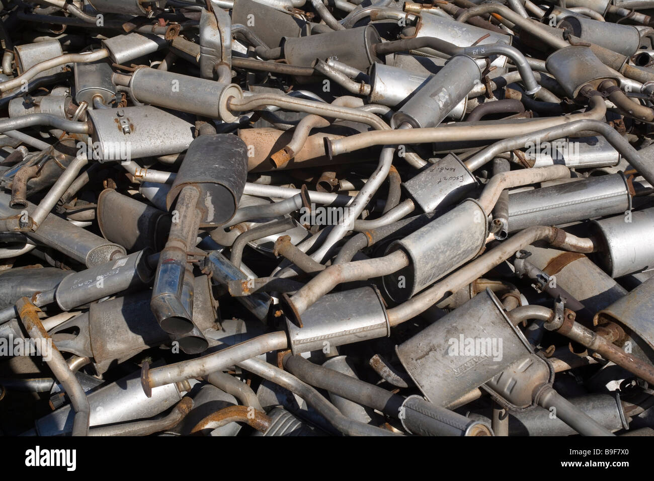 Old exhaust pipes on a scrap yard Stock Photo, Royalty Free Image
