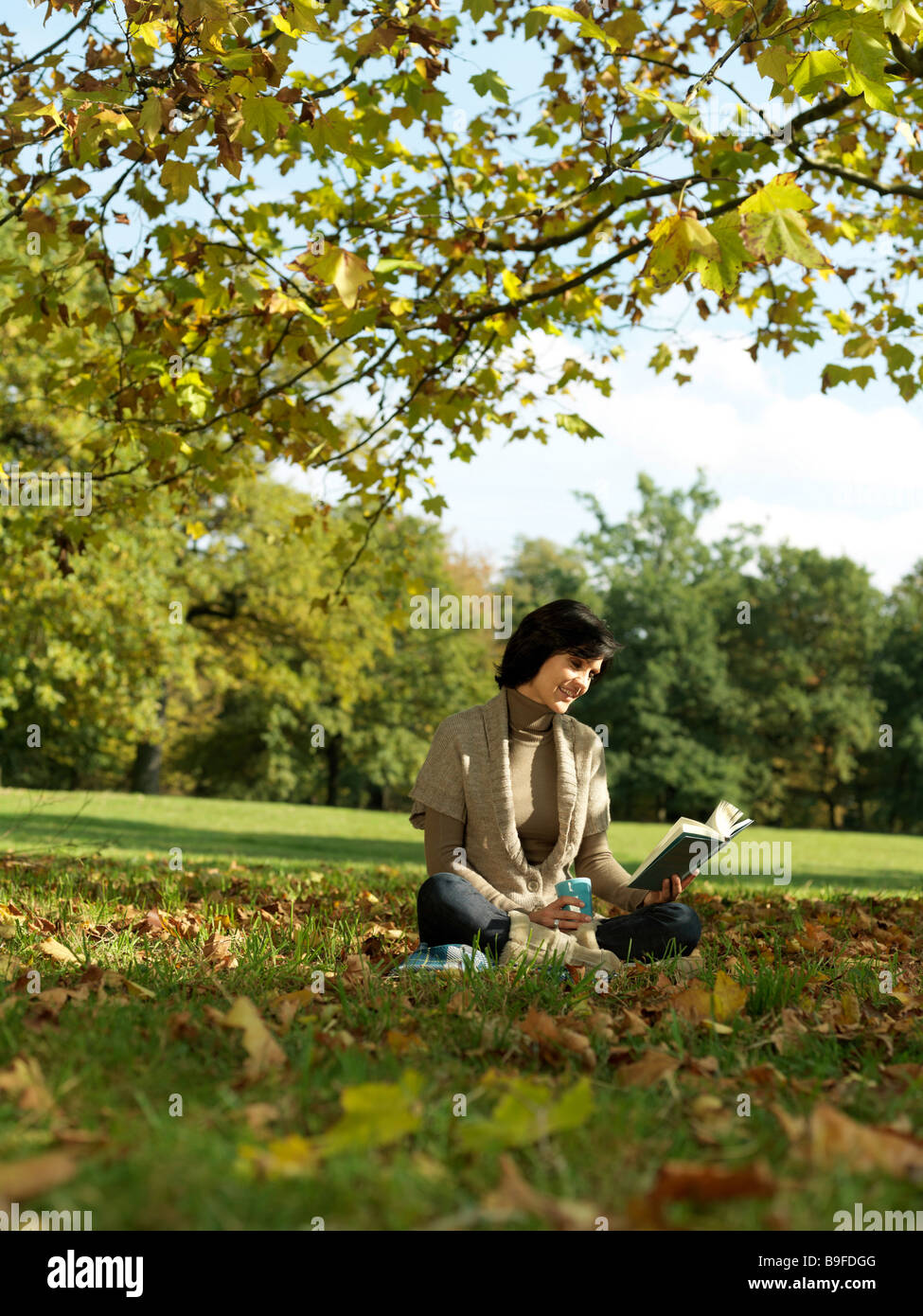 Mature Woman Reading Book In Park Stock Photo Alamy