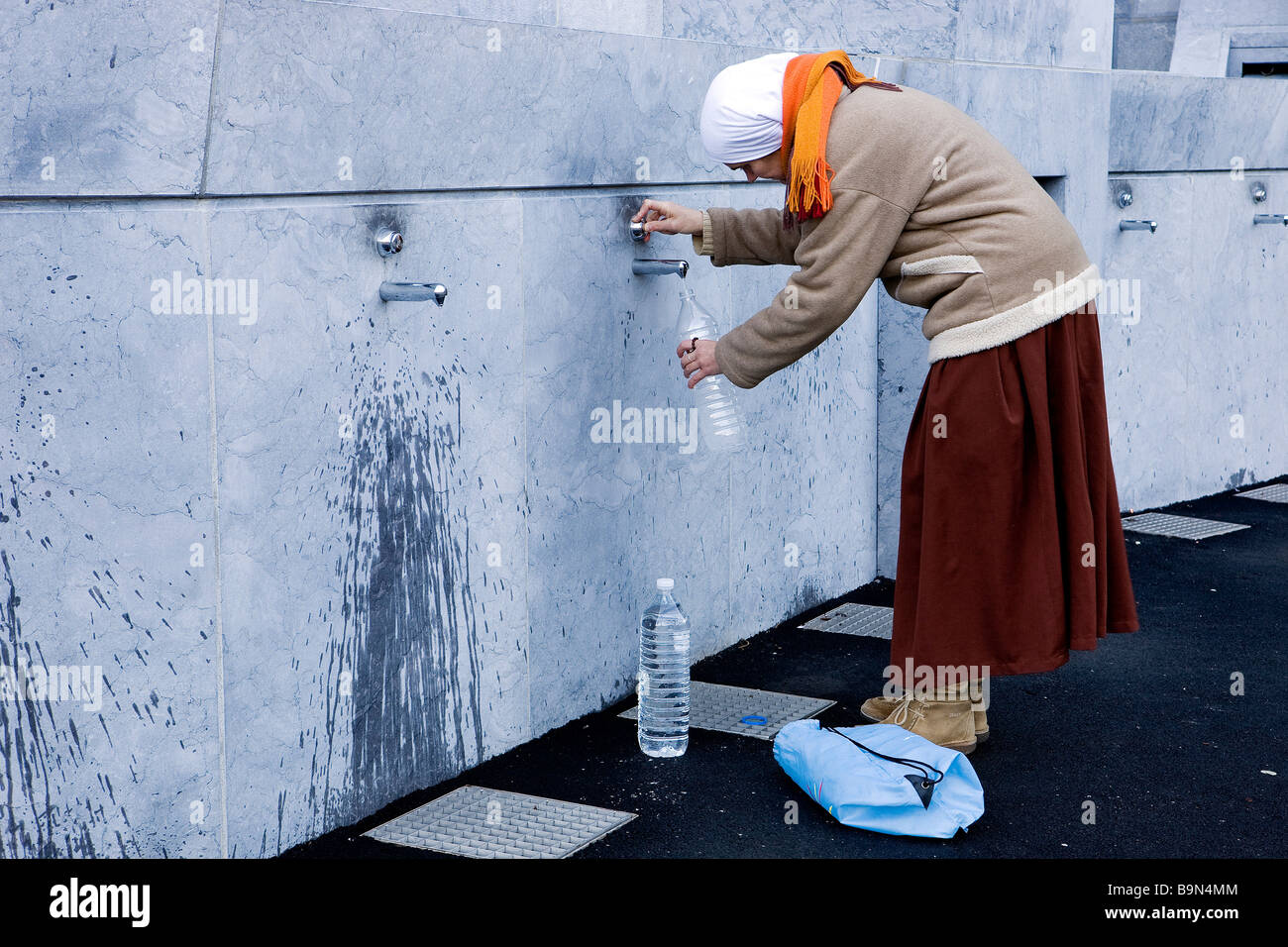 France, Hautes Pyrenees, Lourdes, pilgrim taken spring water in Stock