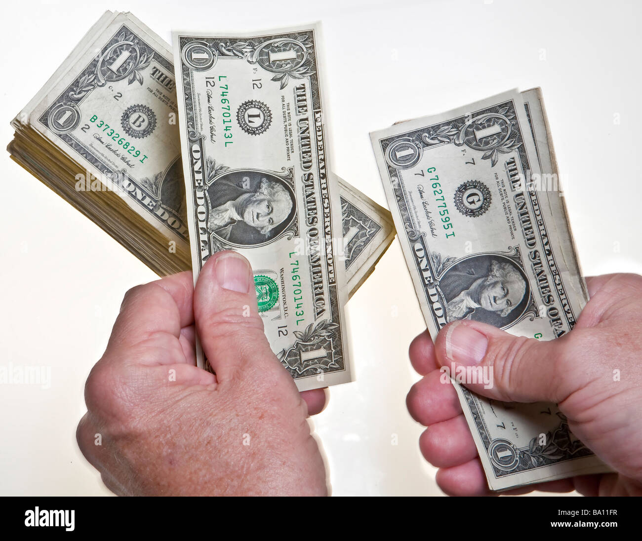 worksheet Counting Dollar Bills older mans hands counting one dollar bills onto a stack on white background