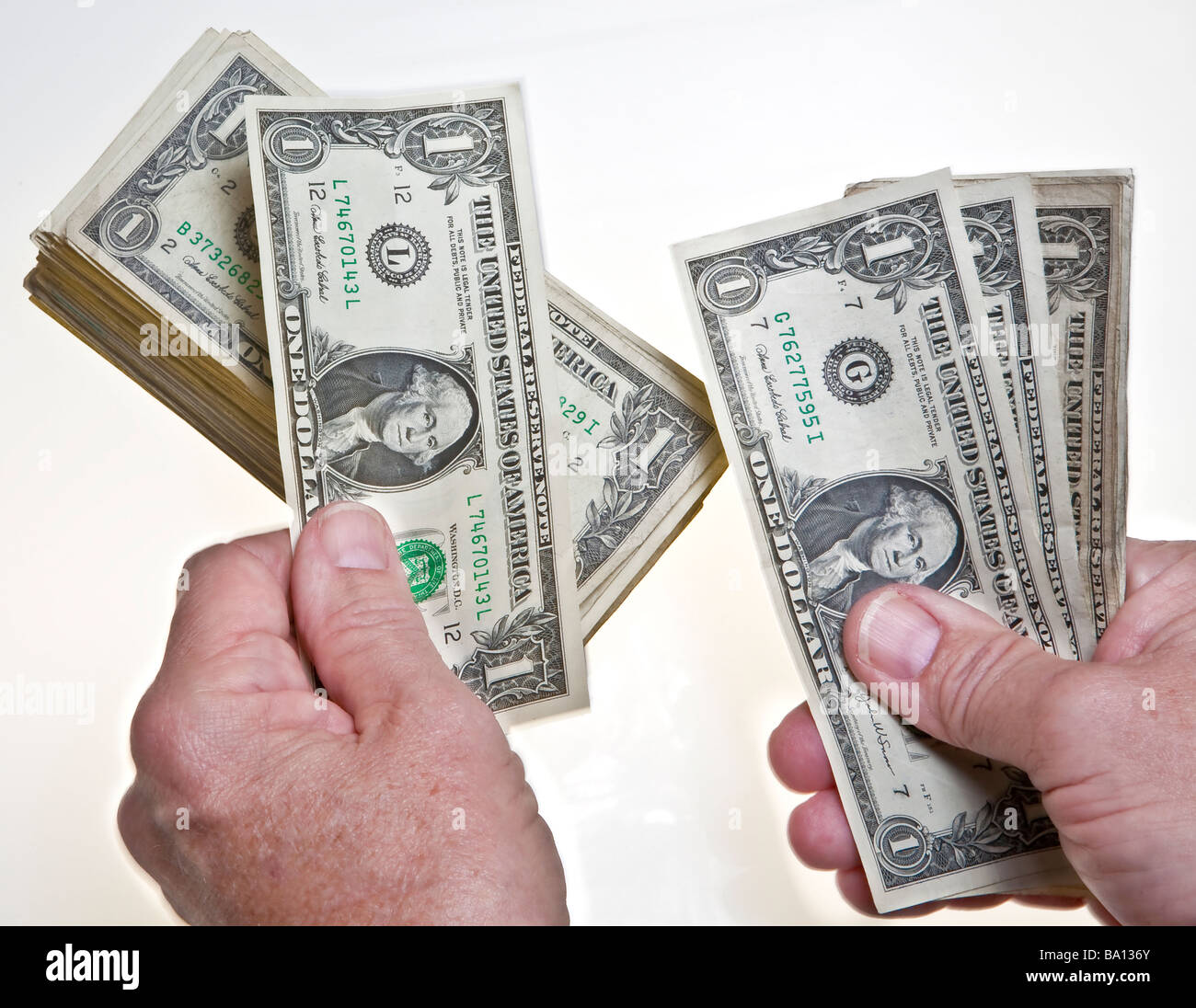 worksheet Counting Dollar Bills older mans hands counting one dollar bills onto a stack on white background