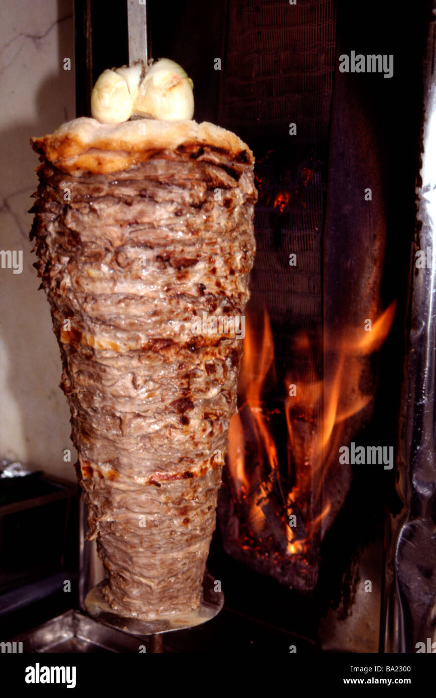Shawarma spitted meat cooking on a rotisserie in the Middle East Stock