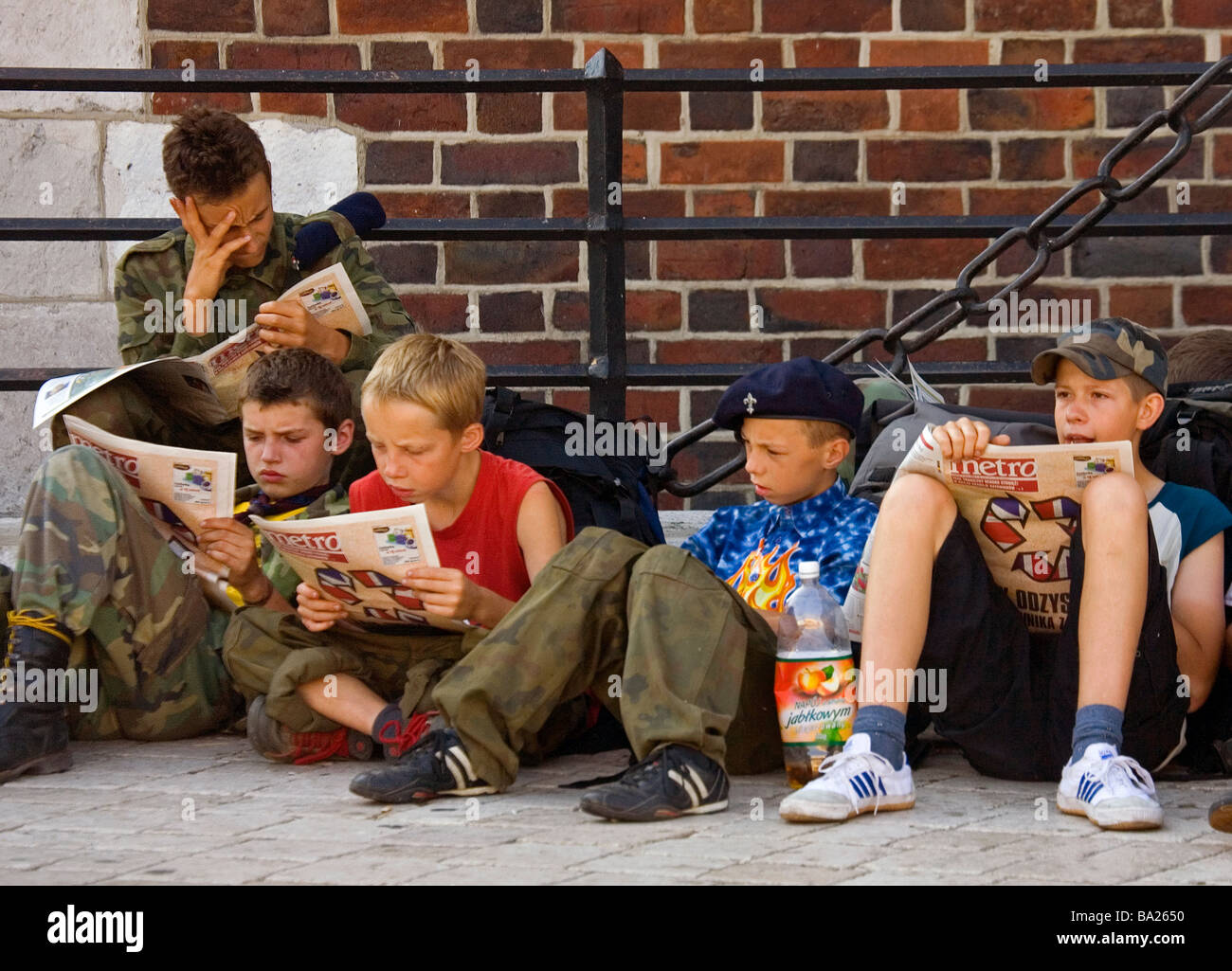 Poland Krakow Main Market Square boy scouts reading newspapers early