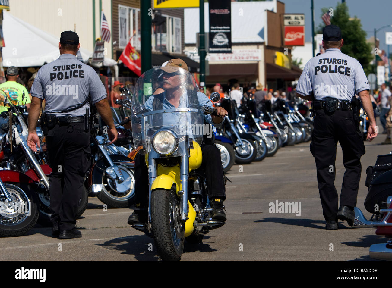 Police officers patrol Sturgis streets on foot and motorcycle during Stock Photo, Royalty Free