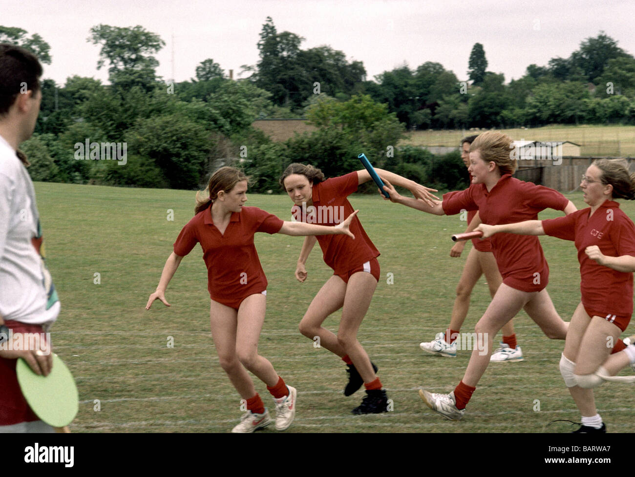 Primary school girls on Sports Day participating in a relay race Stock