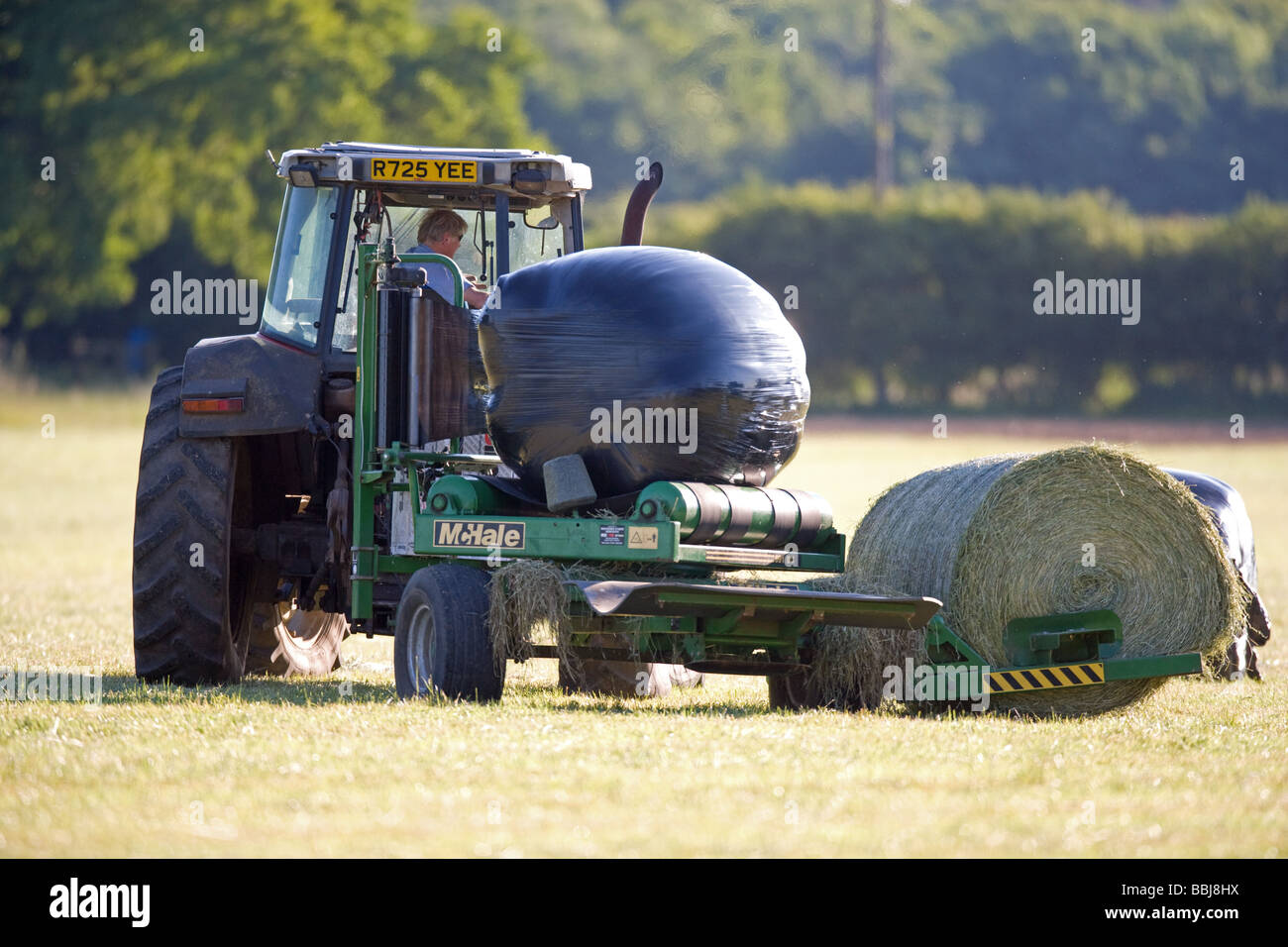 Tractor Wrapping Silage Bales Stock Photo, Royalty Free Image 24373494