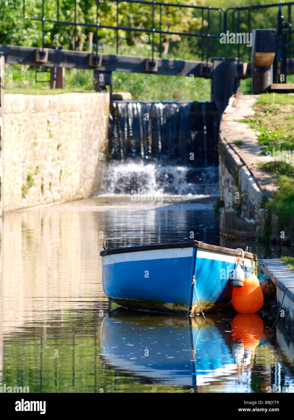 Small rowing boat moored in front of lock gates Stock Photo, Royalty