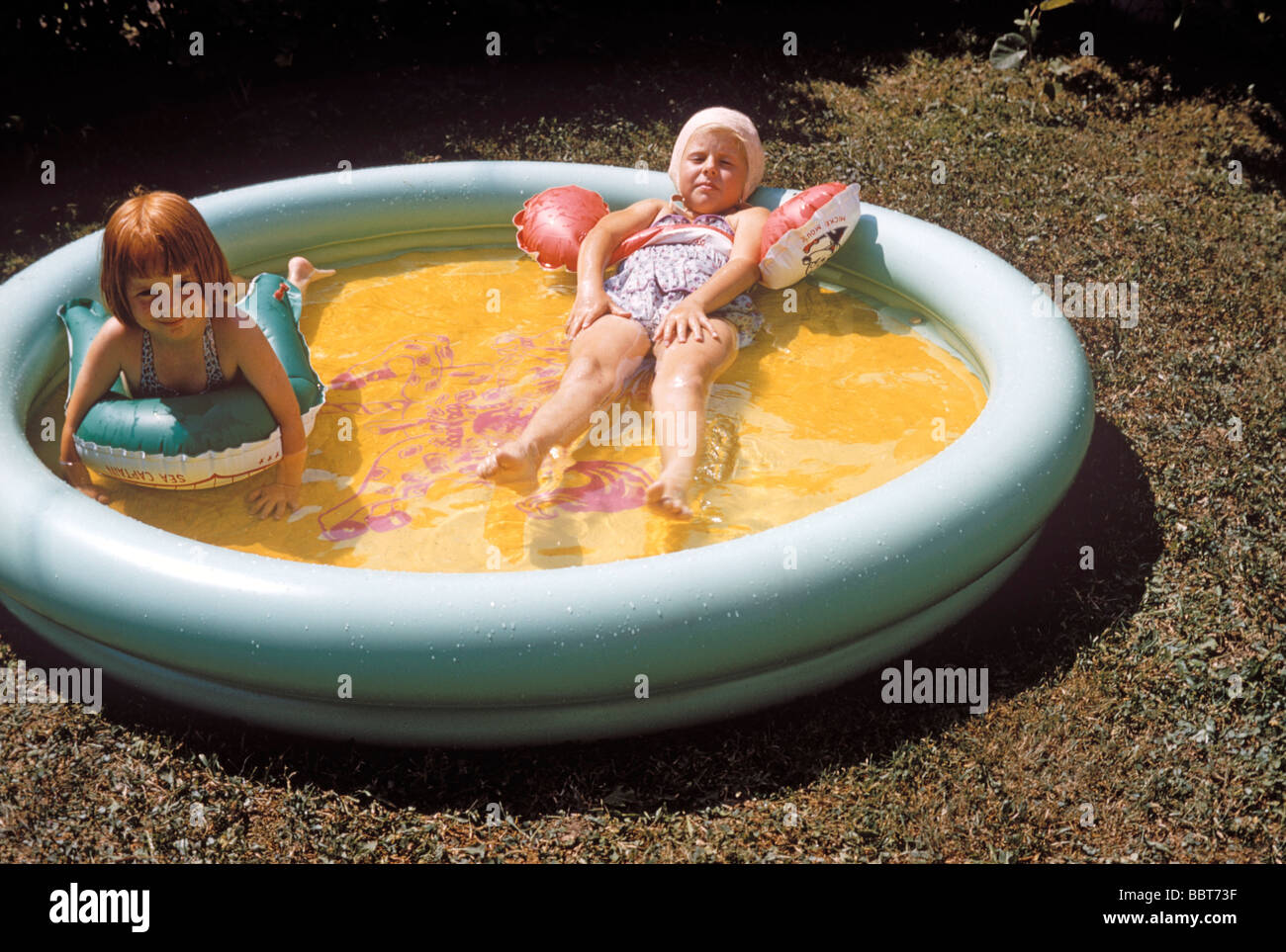 Little girls in a paddling pool 1956 Stock Photo, Royalty Free Image