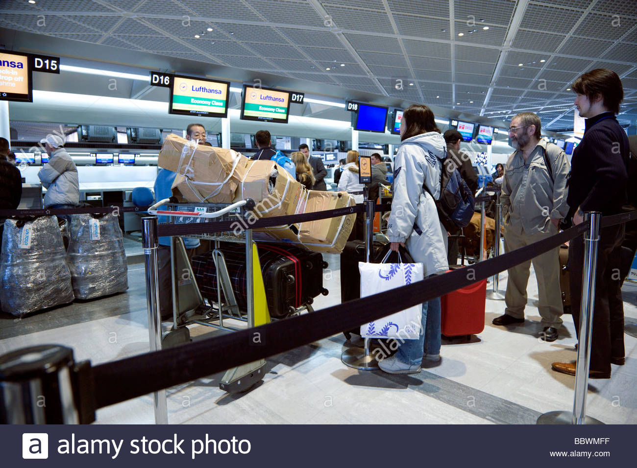 line with passengers at the luggage check in at Narita airport Stock