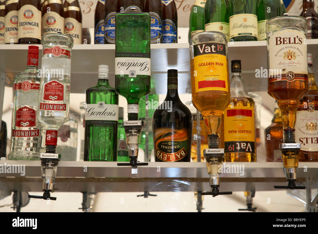 row of alcoholic spirits and bar optics in a bar pub in ireland Stock