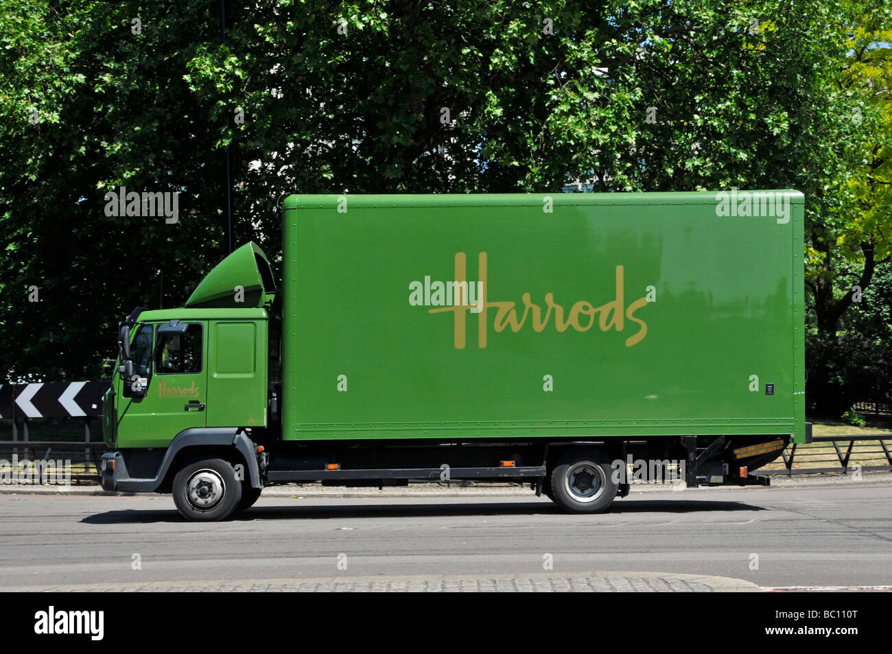 Harrods delivery lorry driving along Park Lane London Stock Photo