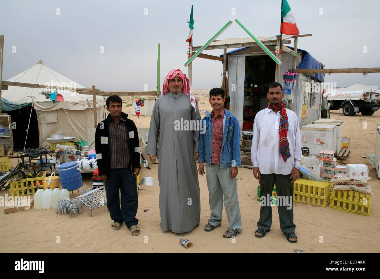 arab-family-pose-in-front-of-caravan-in-kuwait-desert-BD14KK.jpg