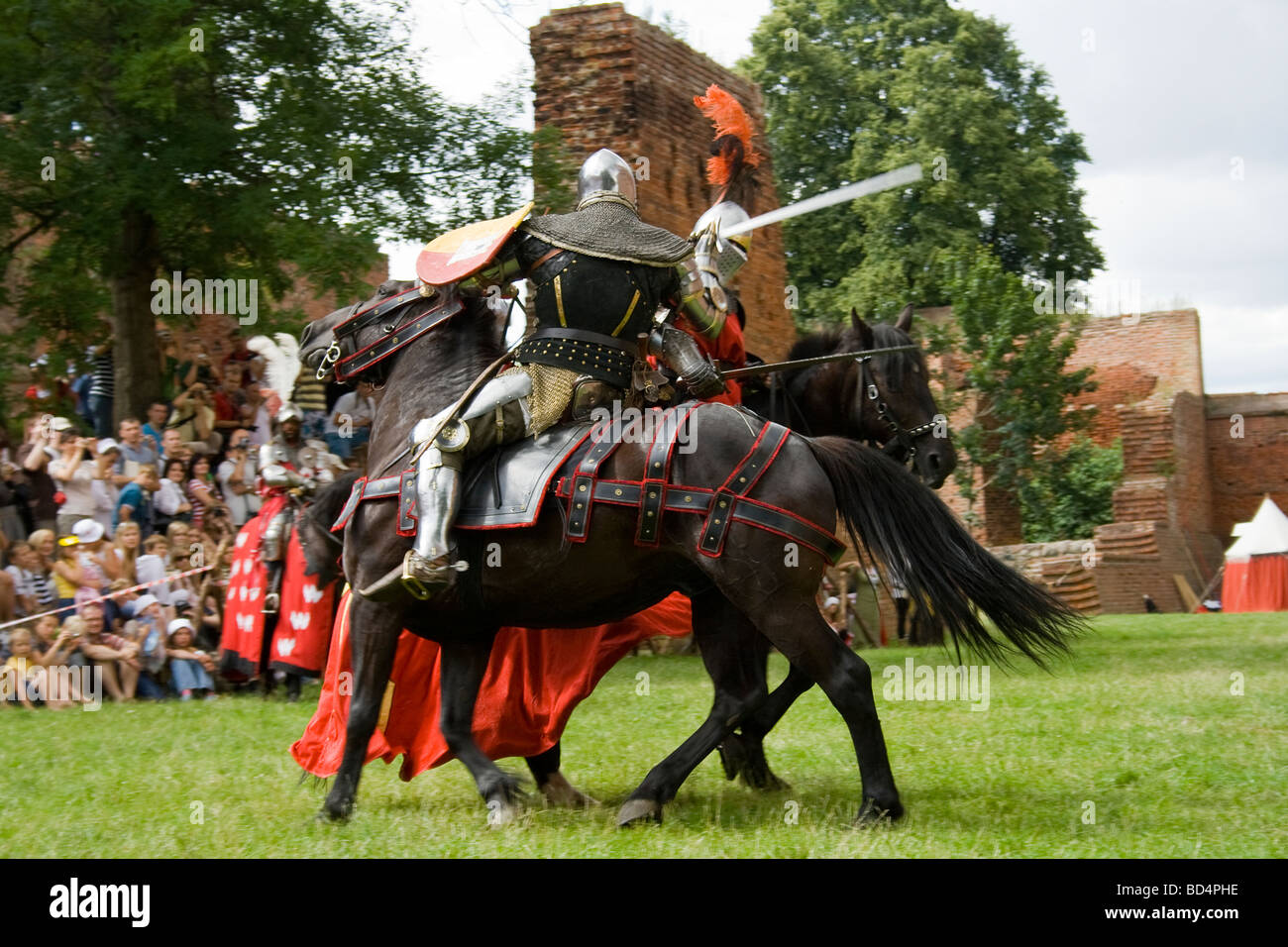 Medieval cavalry knights on military horses fighting with swords Stock