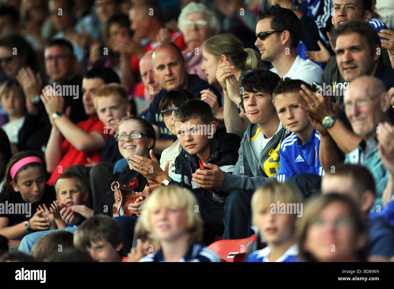 Young faces in the crowd at a football match Stock Photo, Royalty Free