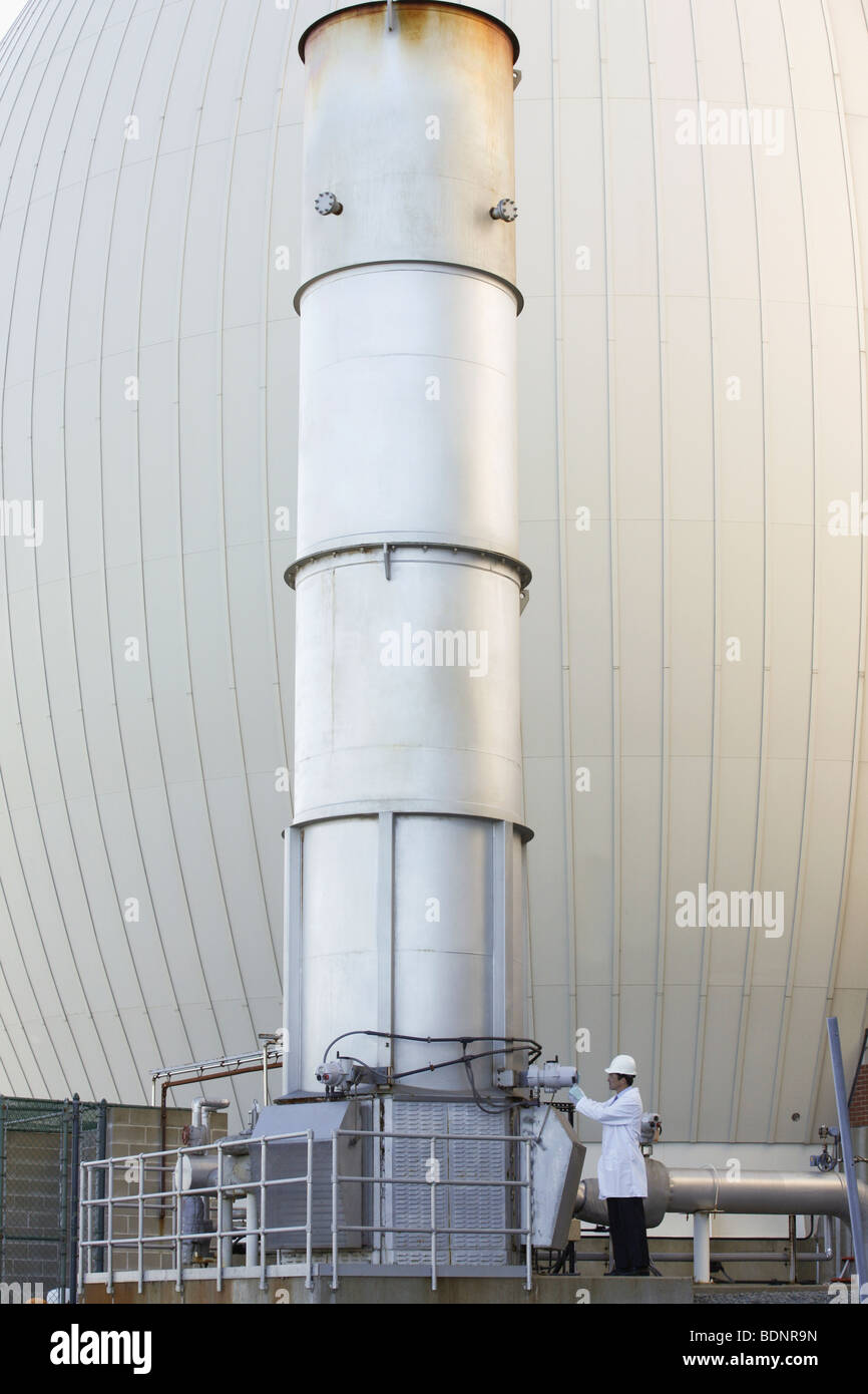 Scientists examining an exhaust stack Stock Photo, Royalty Free Image