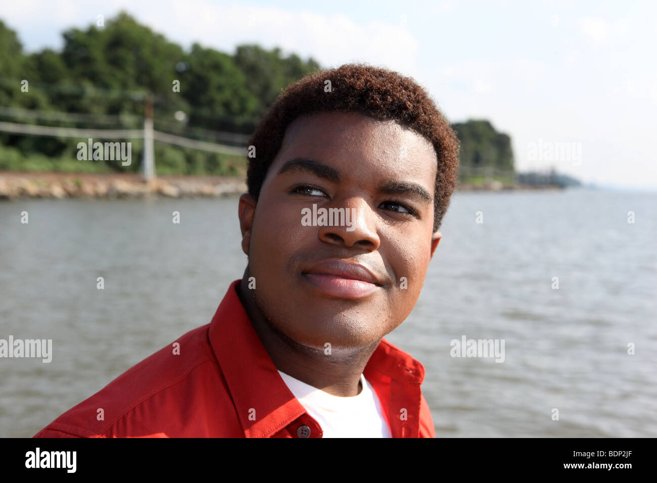 Portrait of young gay man at a Hudson River park in Westchester County, New York - portrait-of-young-gay-man-at-a-hudson-river-park-in-westchester-county-BDP2JF