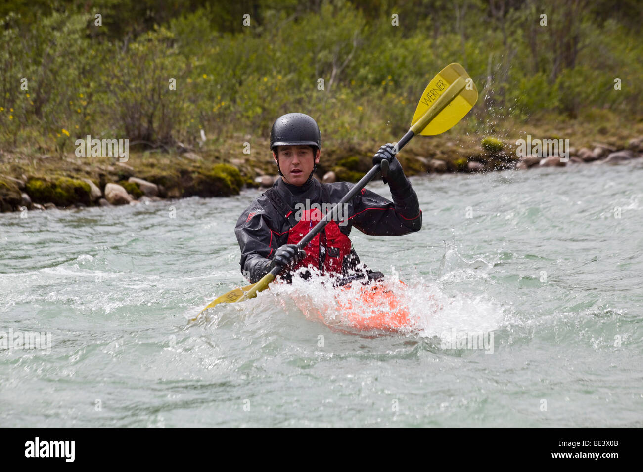 White water kayaking, man paddling a play boat, Wheaton River, Yukon