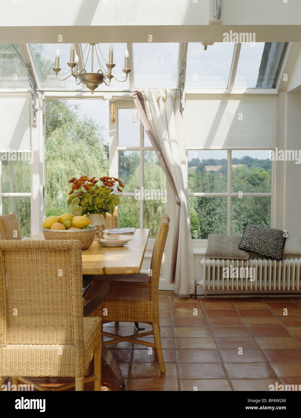 Terracotta tiled floor in conservatory dining room with wicker ... Terracotta tiled floor in conservatory dining room with wicker ...