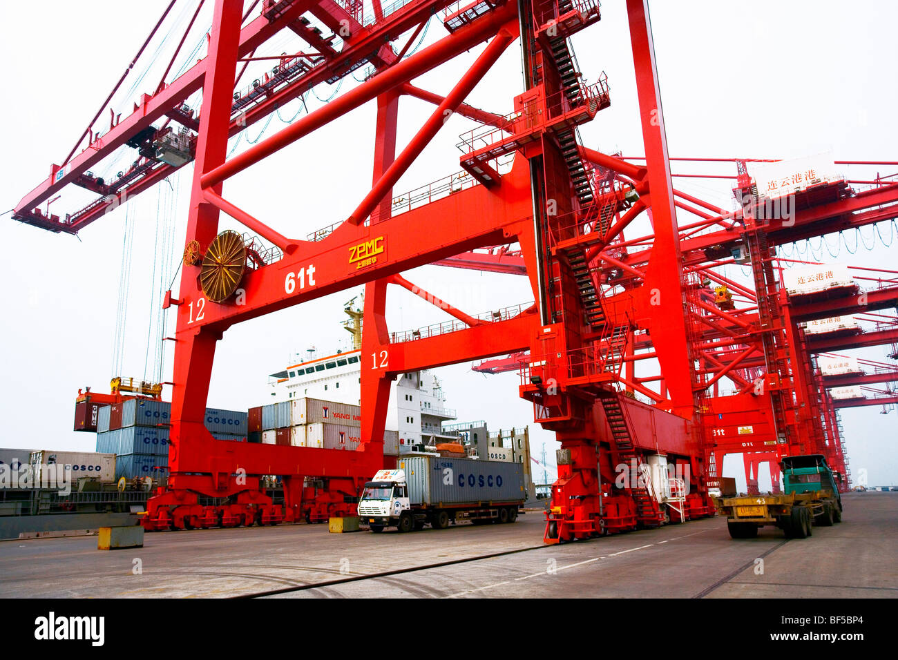 Container crane loading containers onto an ocean freight liner Stock