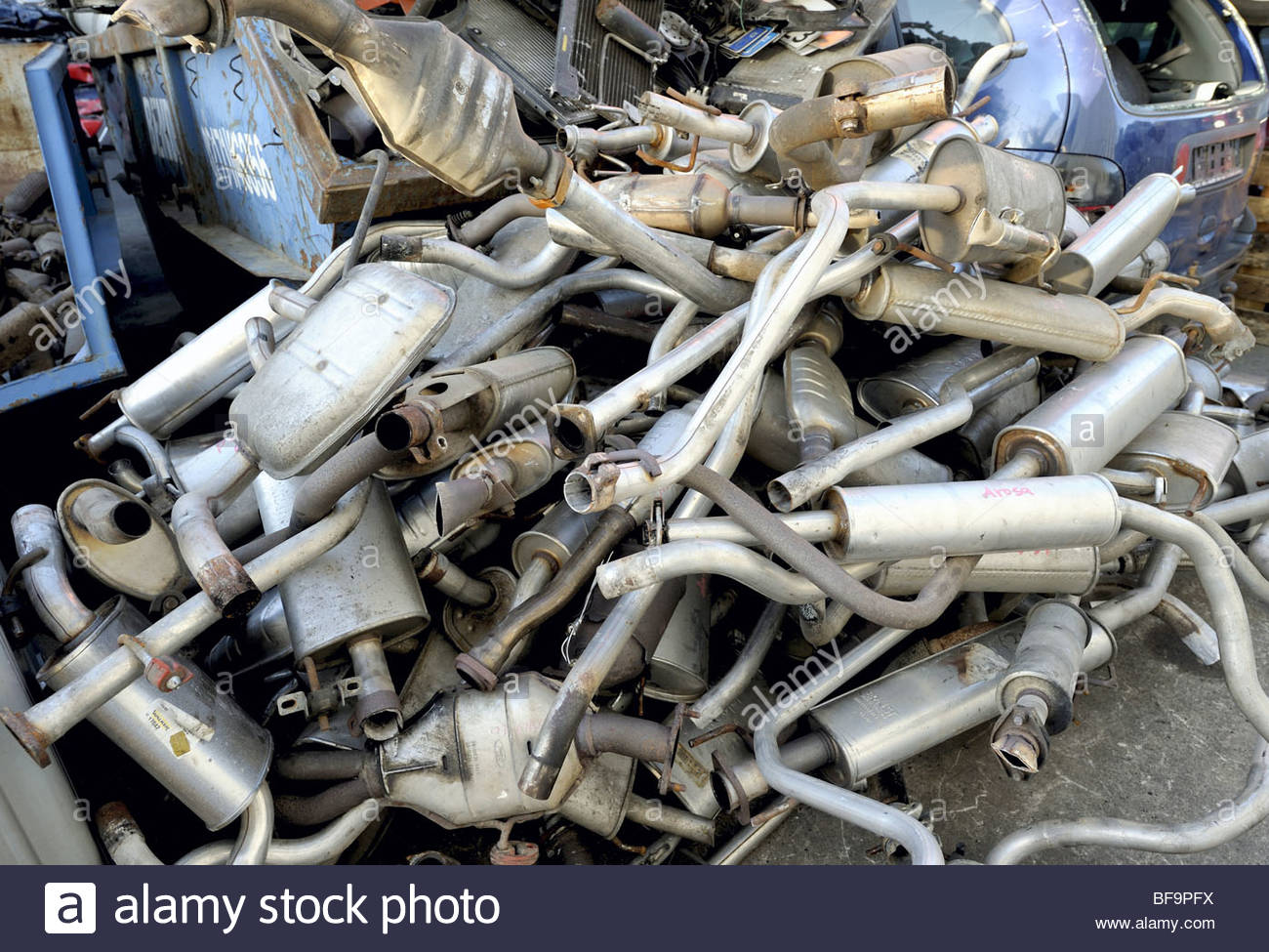 DEU, GERMANY Old exhaust pipes on a scrapyard / junkyard Stock Photo