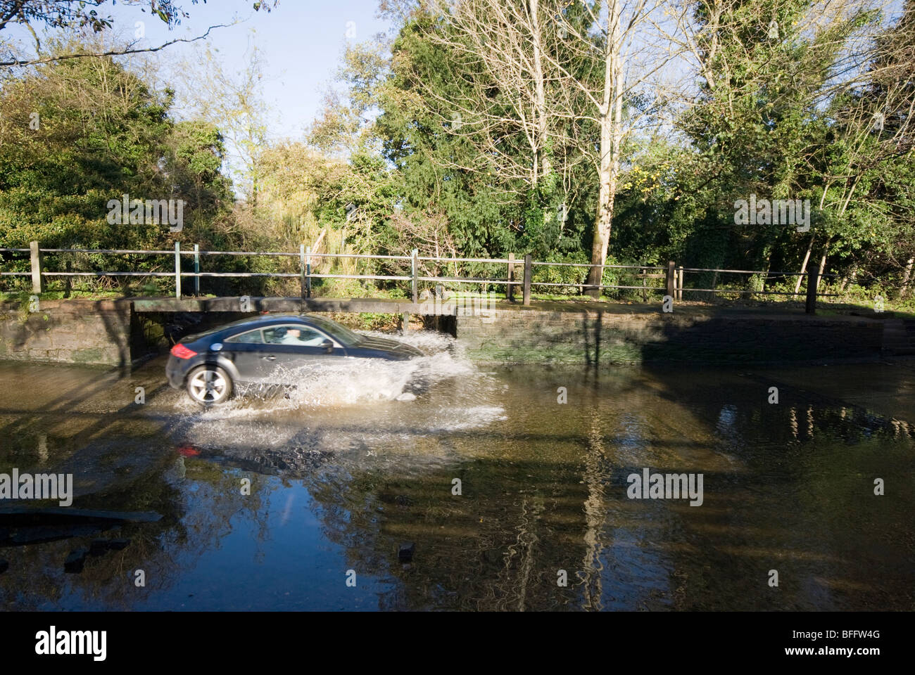 A car driving through a ford at Rufford Lane, near Ollerton Stock Photo