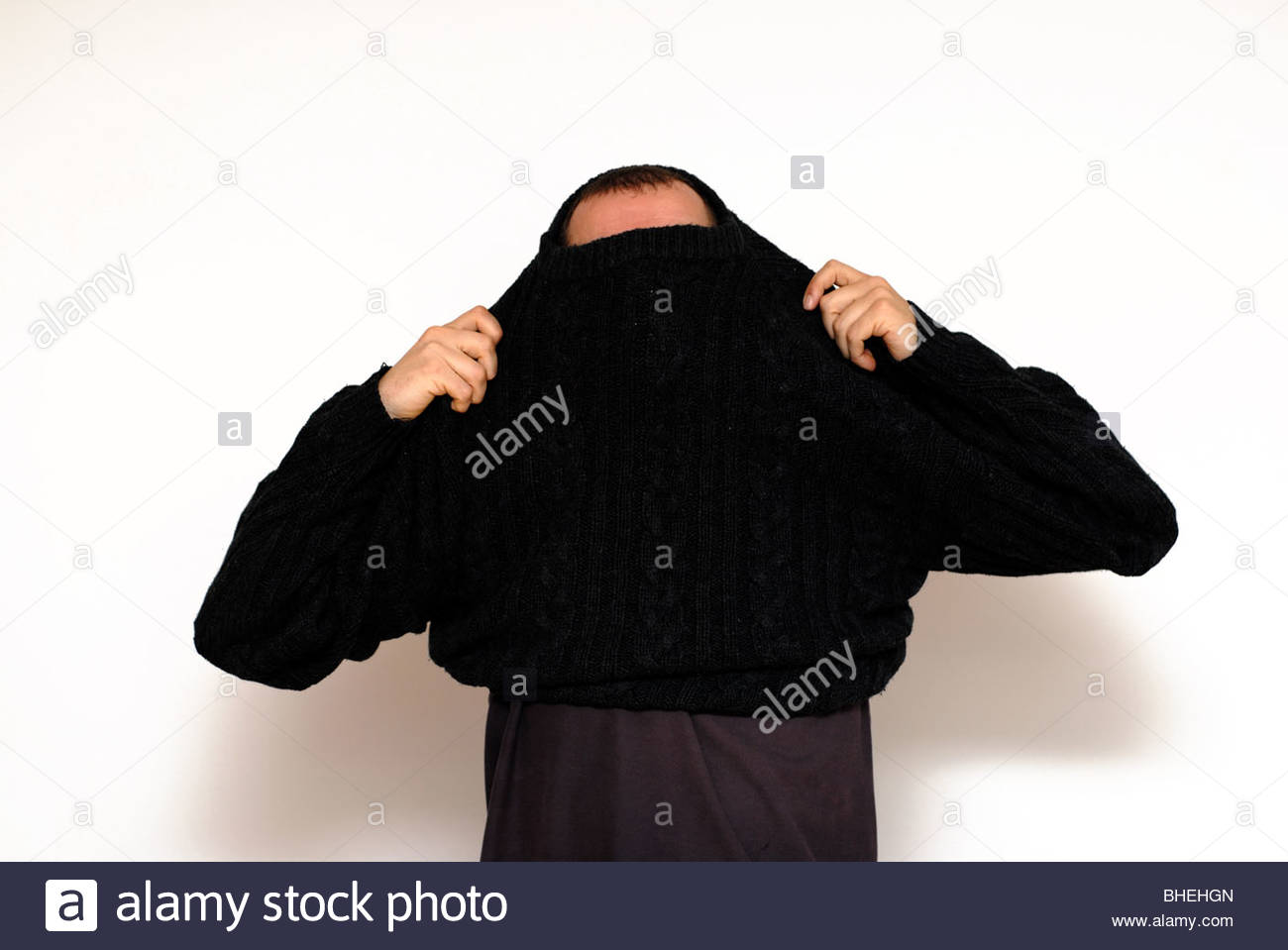 Man putting on a jumper Stock Photo, Royalty Free Image 27980645 Alamy