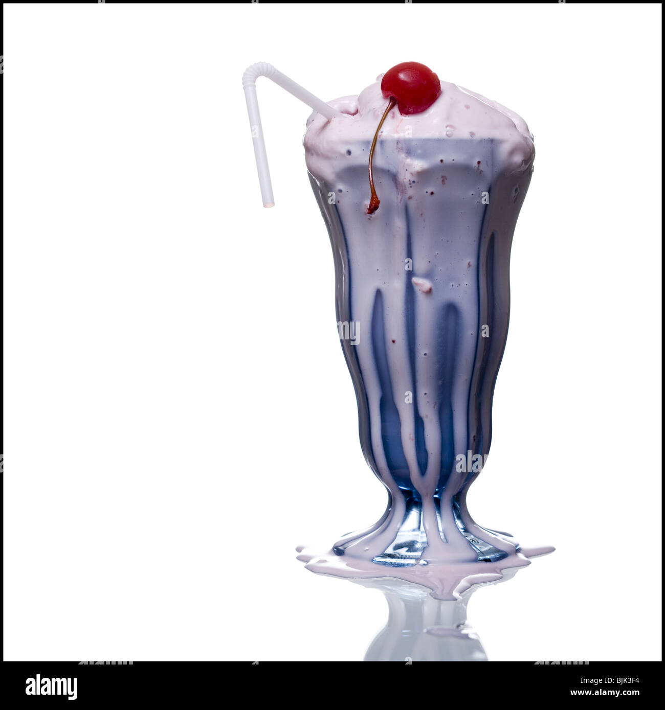 Melting Milkshake With Two Straws And Maraschino Cherry Stock Photo Alamy