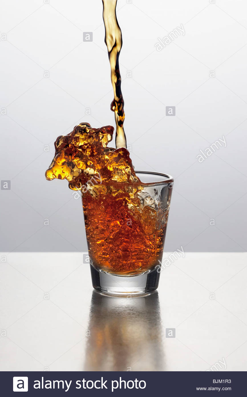 Liquor Pouring into a Shot Glass Stock Photo, Royalty Free Image
