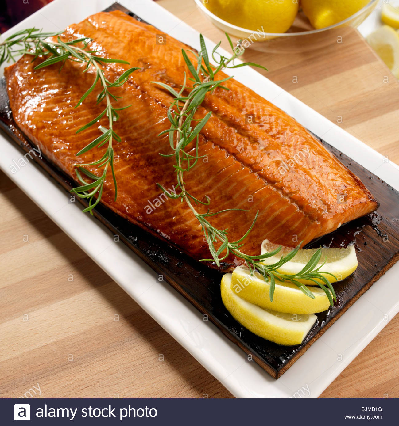 Whole Grilled Salmon Fillet on Cedar Grilling Plank Stock Photo