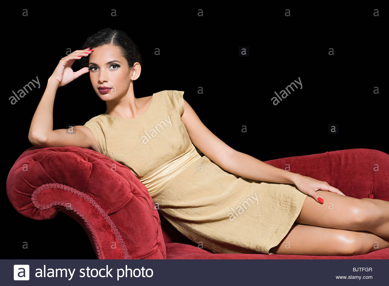 Woman relaxing on a chaise longue Stock Photo, Royalty Free Image