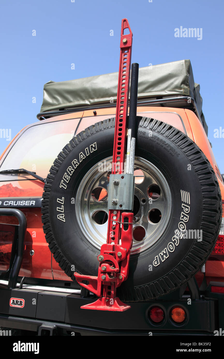 carjack on spare tire of a Toyota Land Cruiser four wheel drive of