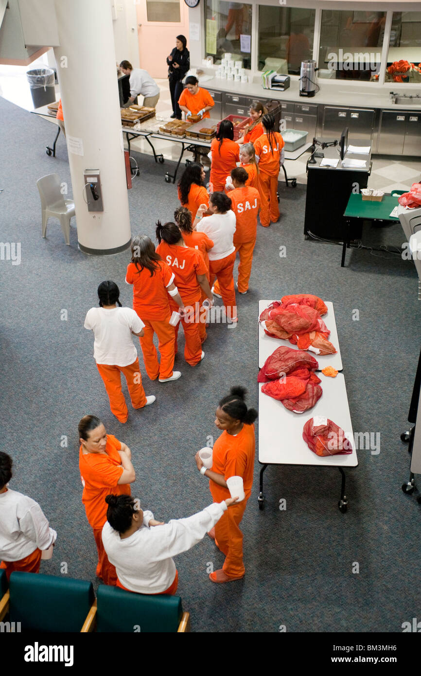 An interracial group of inmates line up for lunch in the Womens Unit