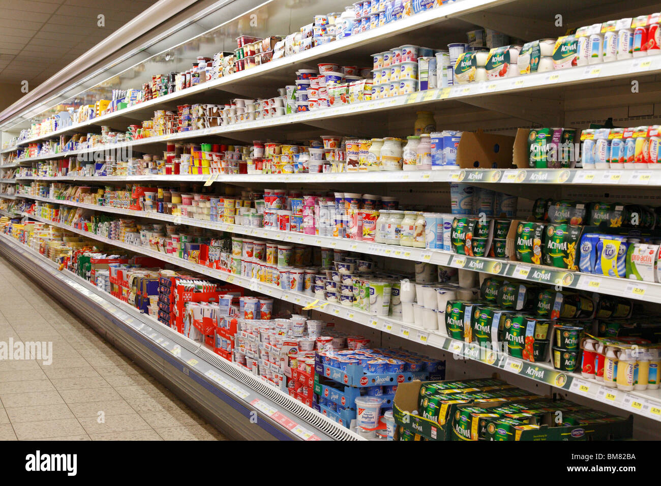 dairy products in a refrigerated shelf in a supermarket Stock Photo