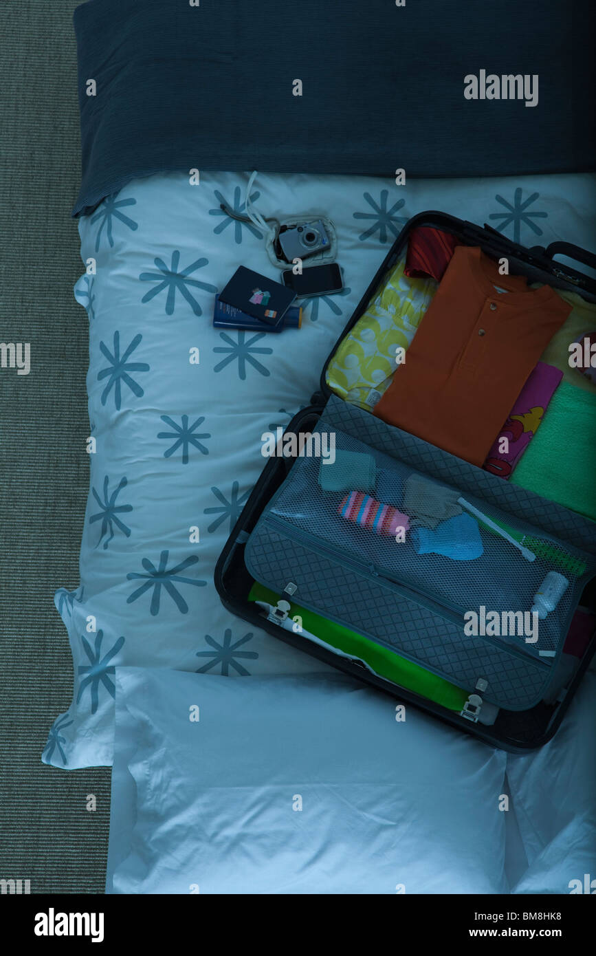 Packed suitcase lying open on bed Stock Photo, Royalty Free Image